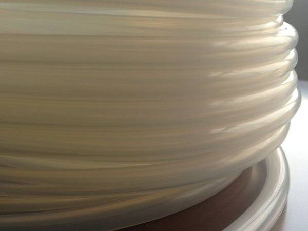 It shows one transparent heat resisting silicone tube rolled on the table.
