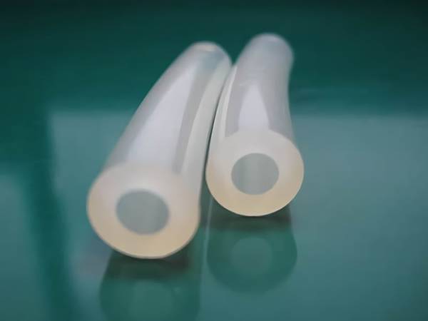 There are two medical silicone tubes displayed on the table.